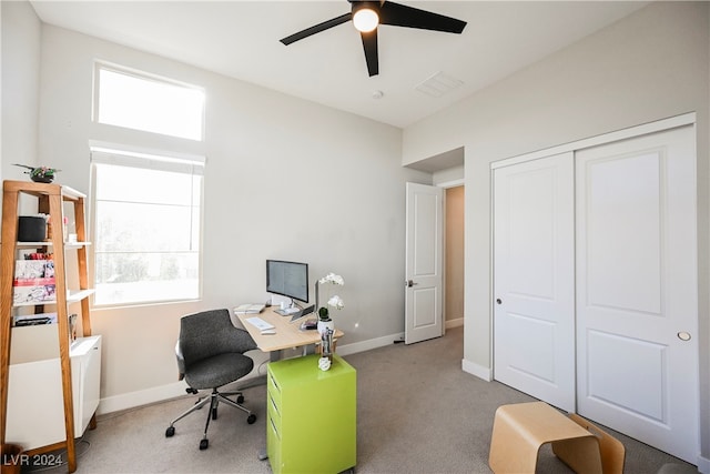 carpeted office featuring a wealth of natural light and ceiling fan