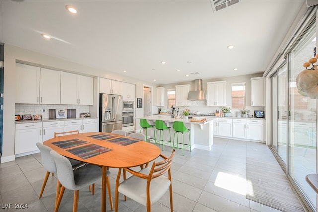 dining space featuring light tile patterned floors