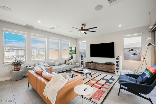 living room with a healthy amount of sunlight, ceiling fan, and light tile patterned floors