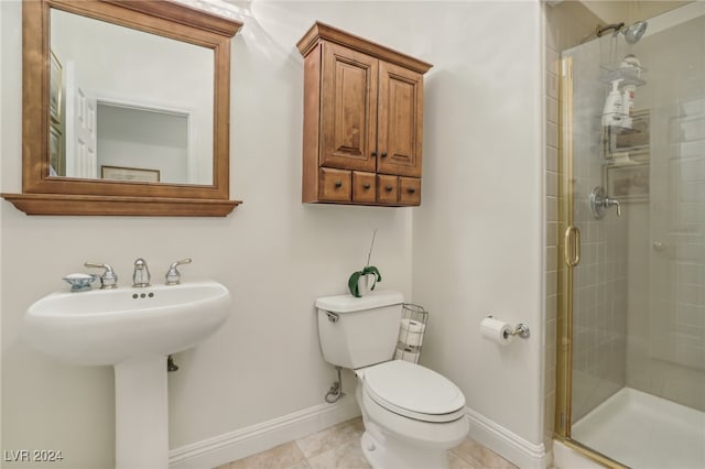 bathroom with sink, tile patterned flooring, toilet, and walk in shower