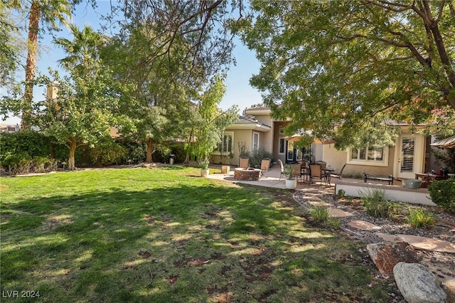 view of yard featuring a patio and an outdoor fire pit