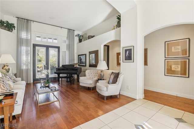 living room with french doors and light wood-type flooring