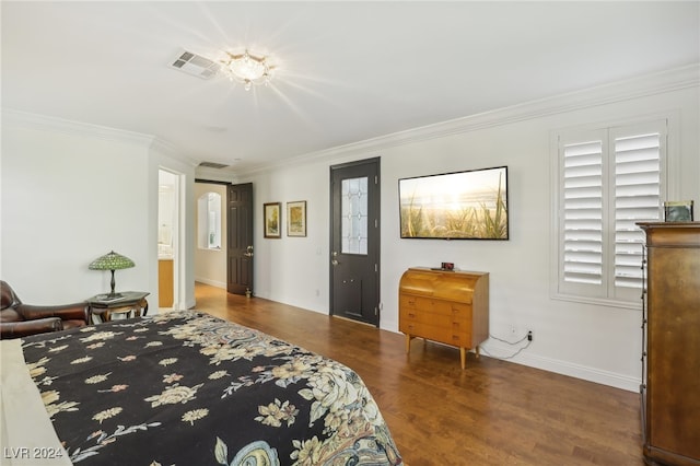 bedroom with ornamental molding and dark hardwood / wood-style flooring