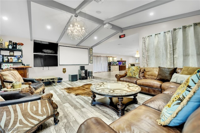 cinema room with light wood-type flooring, a notable chandelier, and vaulted ceiling with beams