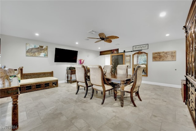 dining space featuring a barn door and ceiling fan