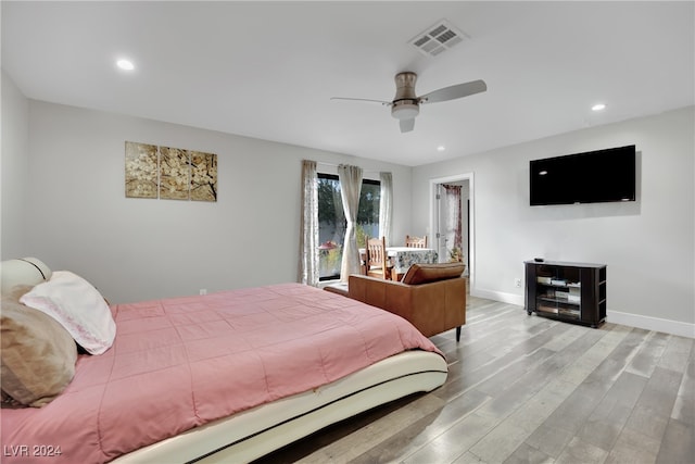 bedroom with light hardwood / wood-style flooring and ceiling fan