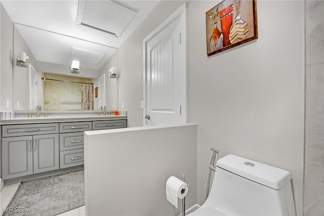 bathroom featuring walk in shower, vanity, tile patterned floors, and toilet