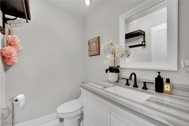 bathroom featuring tile patterned floors, vanity, and toilet