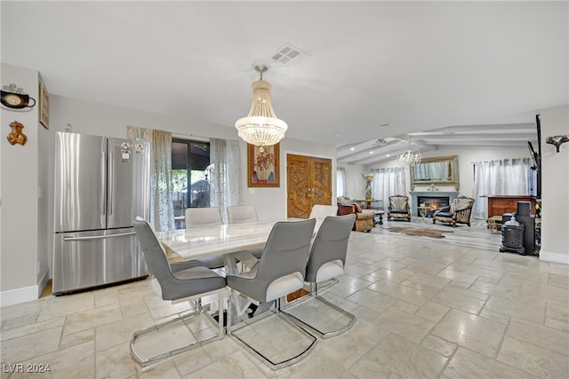 dining space with a chandelier and lofted ceiling