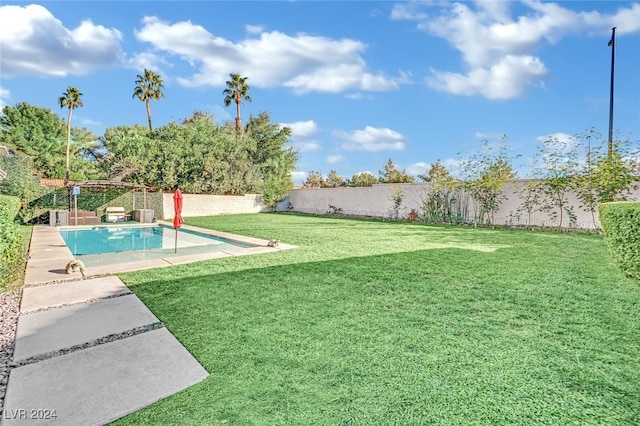 view of yard featuring a fenced in pool and a patio area