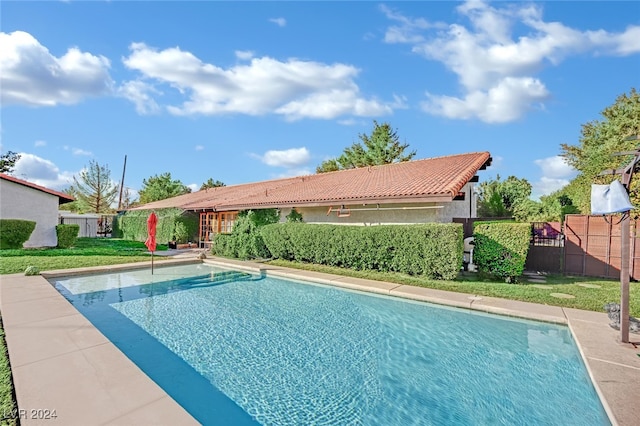 view of swimming pool with a lawn