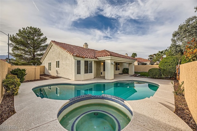 view of swimming pool with an in ground hot tub and a patio