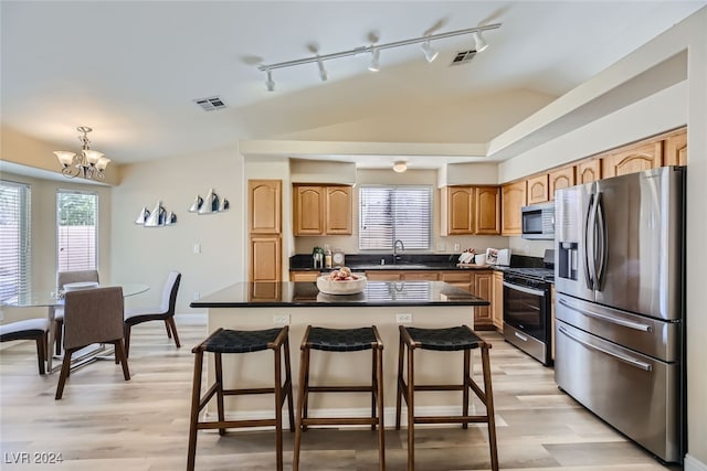 kitchen featuring track lighting, stainless steel appliances, sink, light hardwood / wood-style floors, and a center island