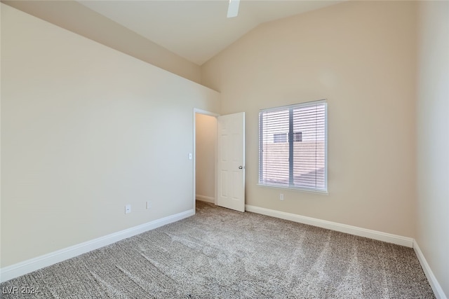 empty room featuring carpet and vaulted ceiling