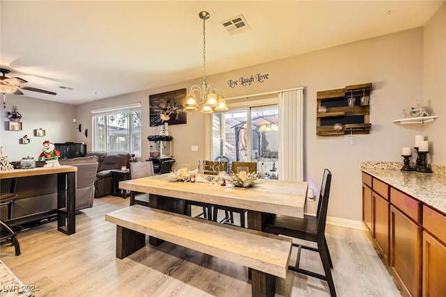 dining area featuring ceiling fan with notable chandelier and light hardwood / wood-style floors