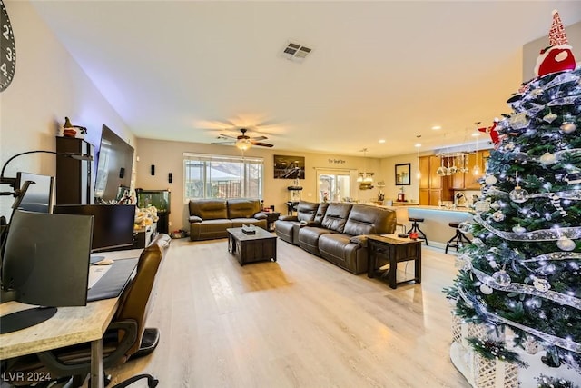 living room with ceiling fan and light hardwood / wood-style floors