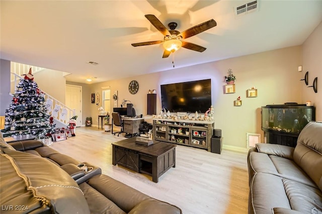 living room featuring ceiling fan and light hardwood / wood-style floors