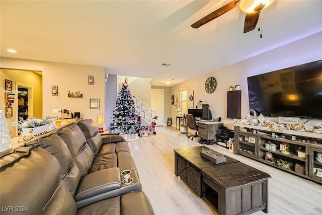 living room with light hardwood / wood-style floors and ceiling fan