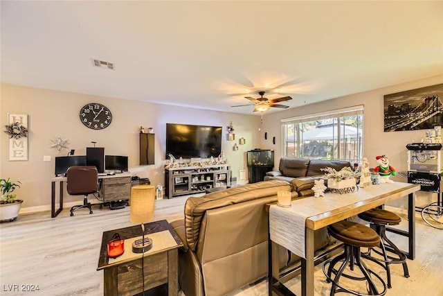 living room with light wood-type flooring and ceiling fan