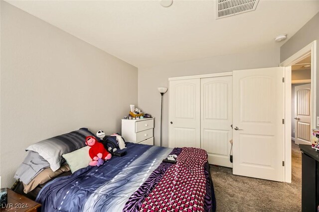 bedroom featuring dark carpet and a closet