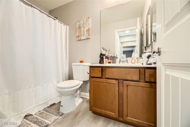 bathroom featuring toilet, vanity, and hardwood / wood-style flooring