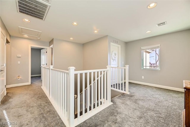 hallway with light colored carpet