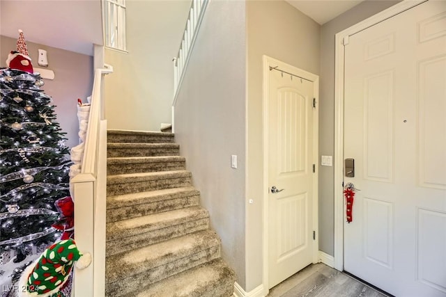 staircase with hardwood / wood-style flooring