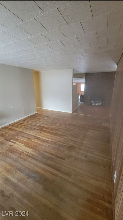 basement featuring a fireplace and hardwood / wood-style flooring