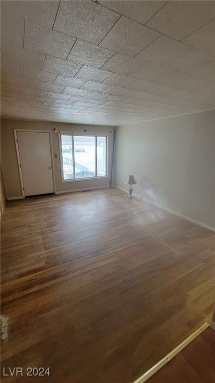 unfurnished room featuring hardwood / wood-style flooring