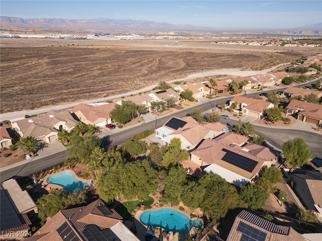 birds eye view of property with a mountain view