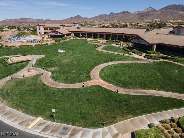 view of community with a yard and a mountain view