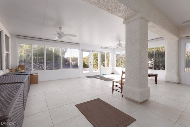 interior space with plenty of natural light, ornate columns, and ceiling fan