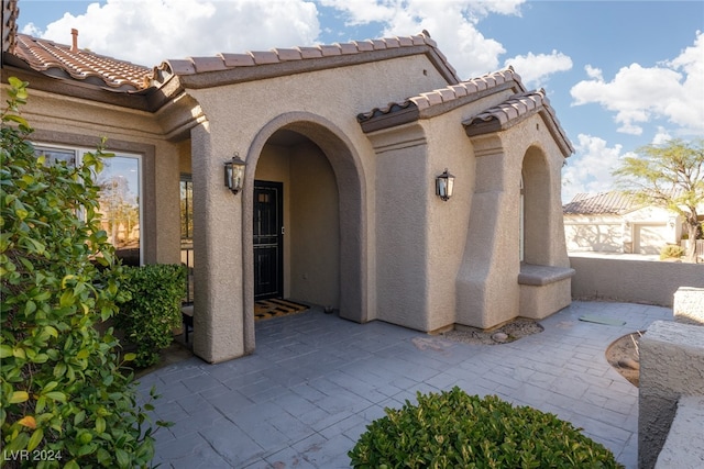 doorway to property with a patio area