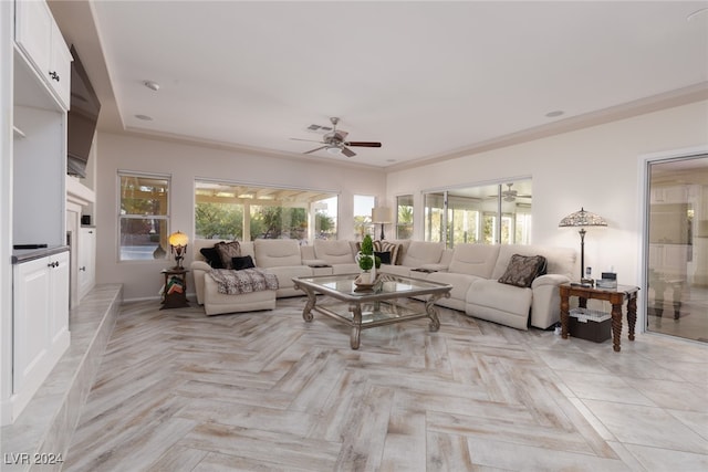 living room featuring ornamental molding, light parquet flooring, and ceiling fan