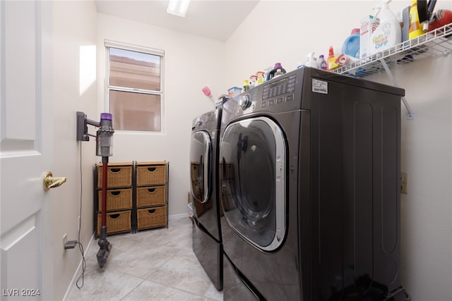 clothes washing area with light tile patterned floors and washing machine and clothes dryer