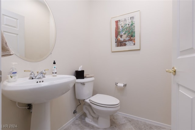 bathroom featuring toilet and tile patterned flooring