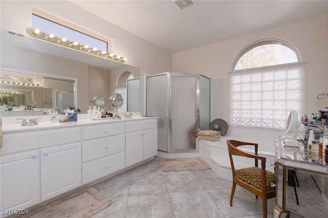 bathroom with a shower with door and vanity