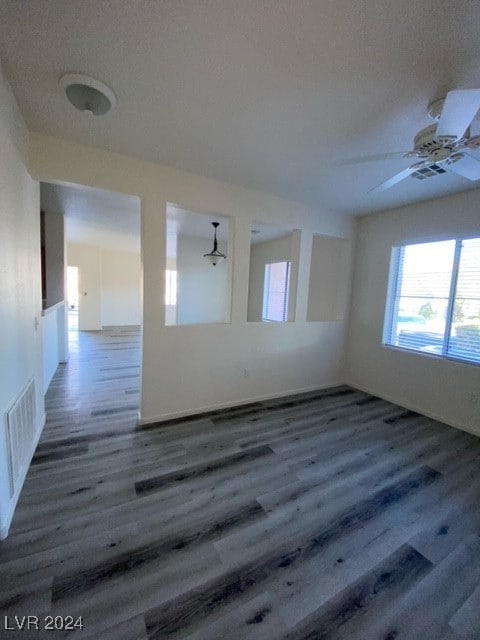 empty room featuring dark hardwood / wood-style floors and ceiling fan