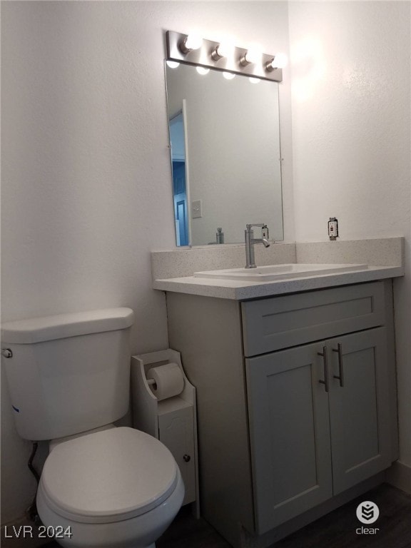 bathroom with toilet and vanity