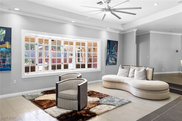 living room with ornamental molding and ceiling fan