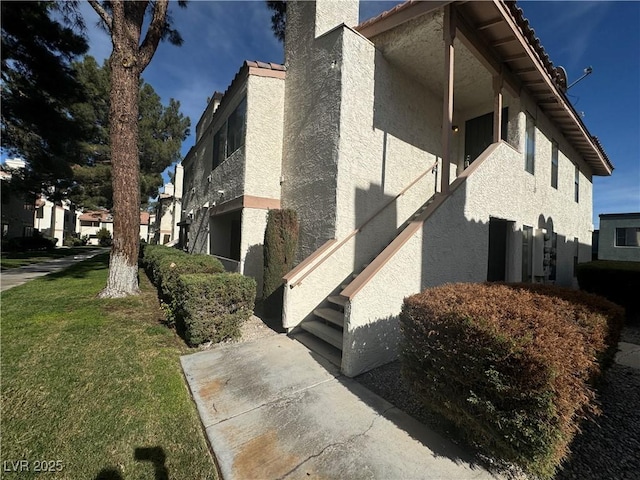 view of side of home featuring a yard