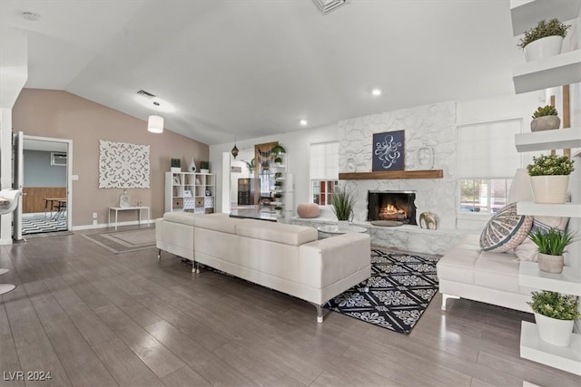 living room with vaulted ceiling, a fireplace, and dark hardwood / wood-style flooring