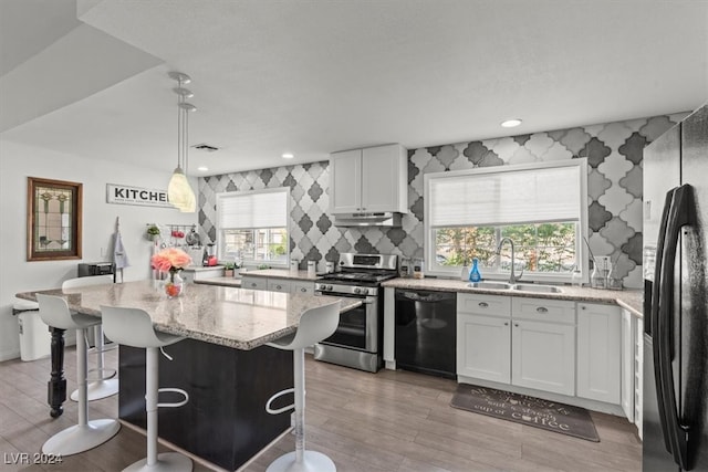 kitchen with sink, dishwasher, stainless steel stove, fridge with ice dispenser, and white cabinets