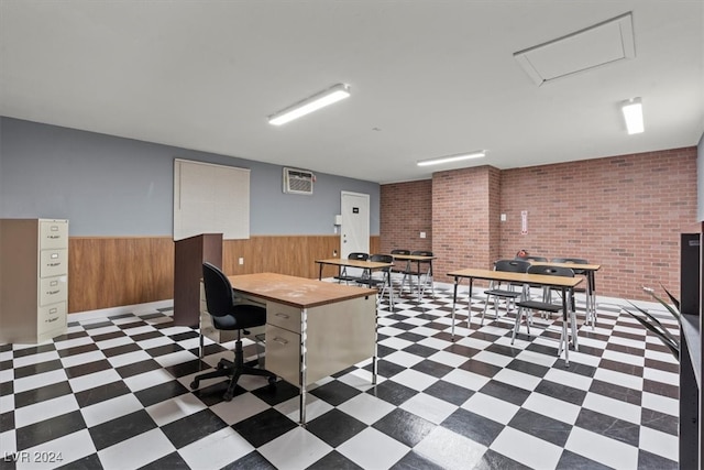 office area with a wall mounted air conditioner, wood walls, and brick wall