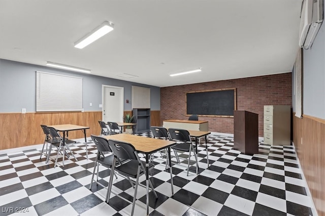 game room featuring wood walls, a wall mounted AC, and brick wall