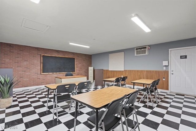 dining area with an AC wall unit, brick wall, and wooden walls