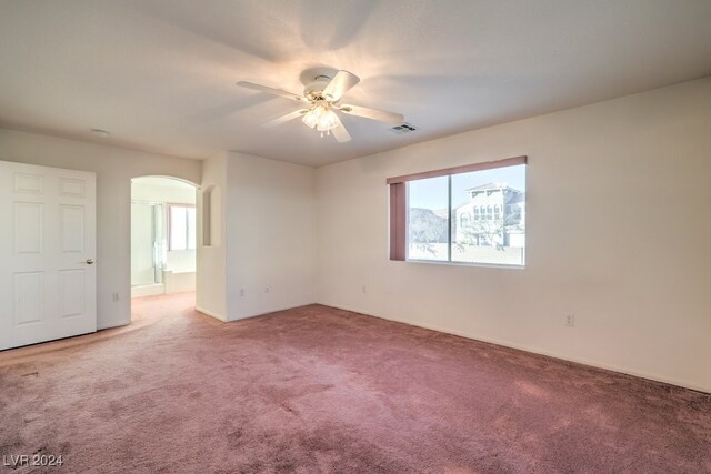 carpeted empty room featuring ceiling fan