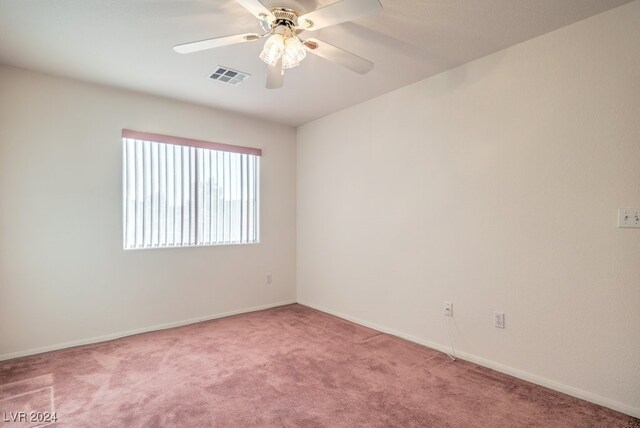 spare room with light carpet and ceiling fan