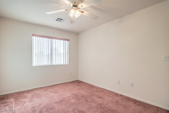 empty room with light colored carpet and ceiling fan