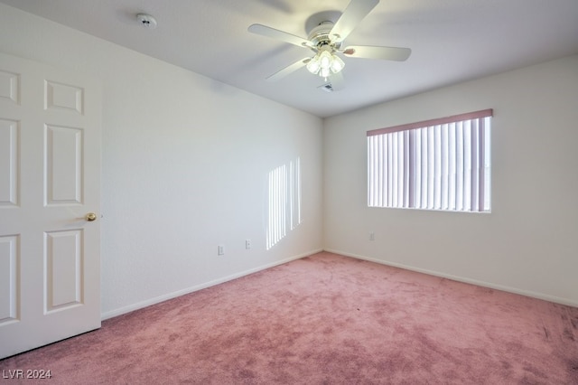 unfurnished room with light colored carpet and ceiling fan